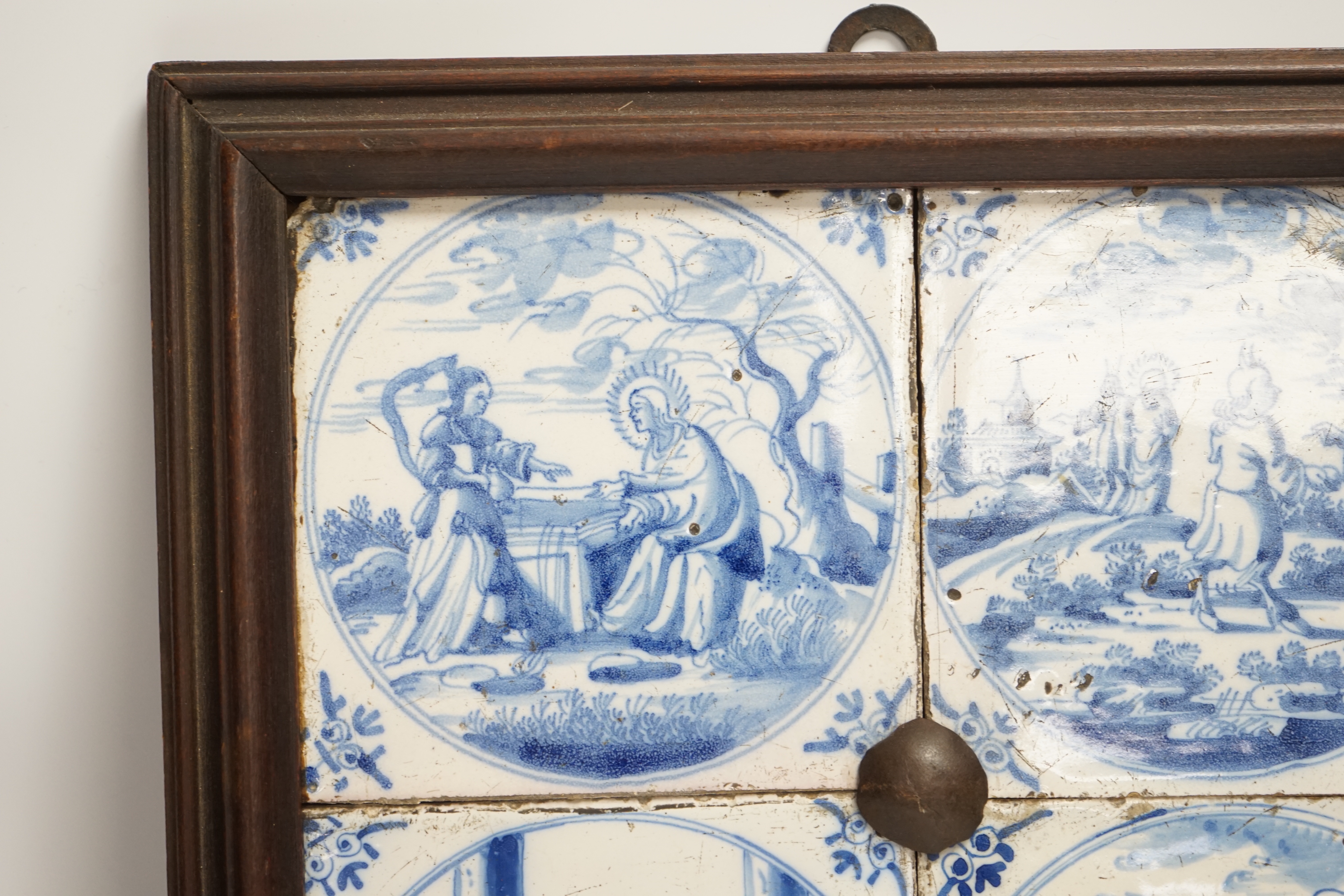 Four framed 19th century Delft ‘bible story’ tiles, 31cm x 31cm